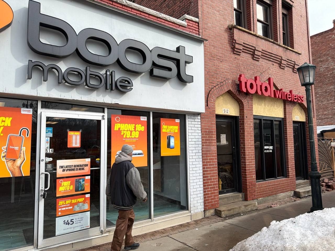 An RBFC Boost Mobile storefront with current pricing in the windows